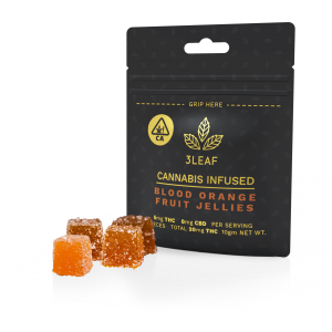 3Leaf low-dosed Blood Orange Fruit Jellies. Four fruit jellies, lightly coated in sugar, are placed in front of a 3Leaf package.