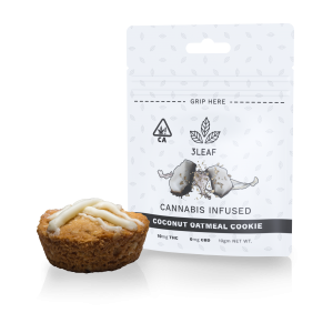 3Leaf natural Coconut Oatmeal Cookie. One cookie, drizzled with white chocolate, is placed in front of a 3Leaf package.