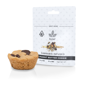 3Leaf ratio-infused Peanut Butter Cookie. One peanut butter cookie with chocolate chips is placed in front of the 3Leaf package.