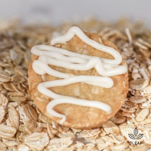 A Coconut Oatmeal Cookie from 3Leaf Edibles. Contains oats, coconut, agave nectar, and a white chocolate drizzle. Infused with 10 milligrams of THC distillate.