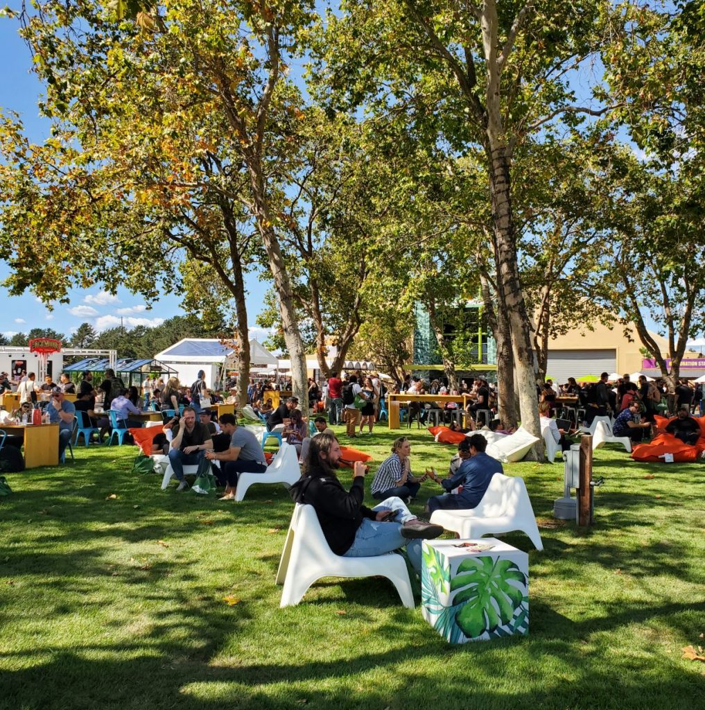 Attendees partaking in cannabis at Hall of Flowers under the California sun.